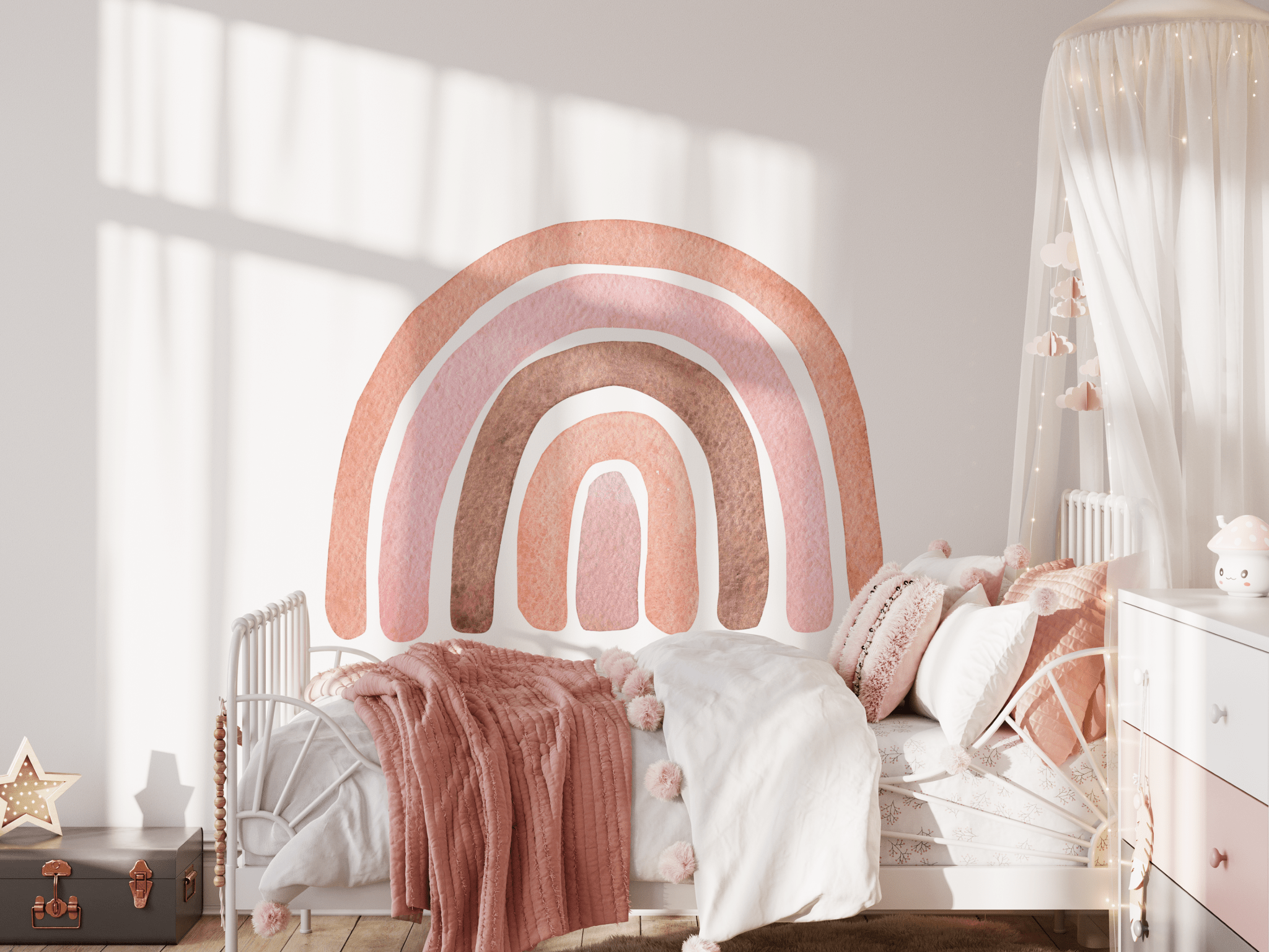 A cozy girls' bedroom with an Autumn Rainbow wall decal above the bed. The room features a soft pink blanket, white metal bed frame, and a dreamy canopy, creating a warm and inviting space.