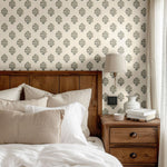 Cozy bedroom featuring a charming blue floral wallpaper paired with warm wooden furniture and neutral bedding for a serene atmosphere