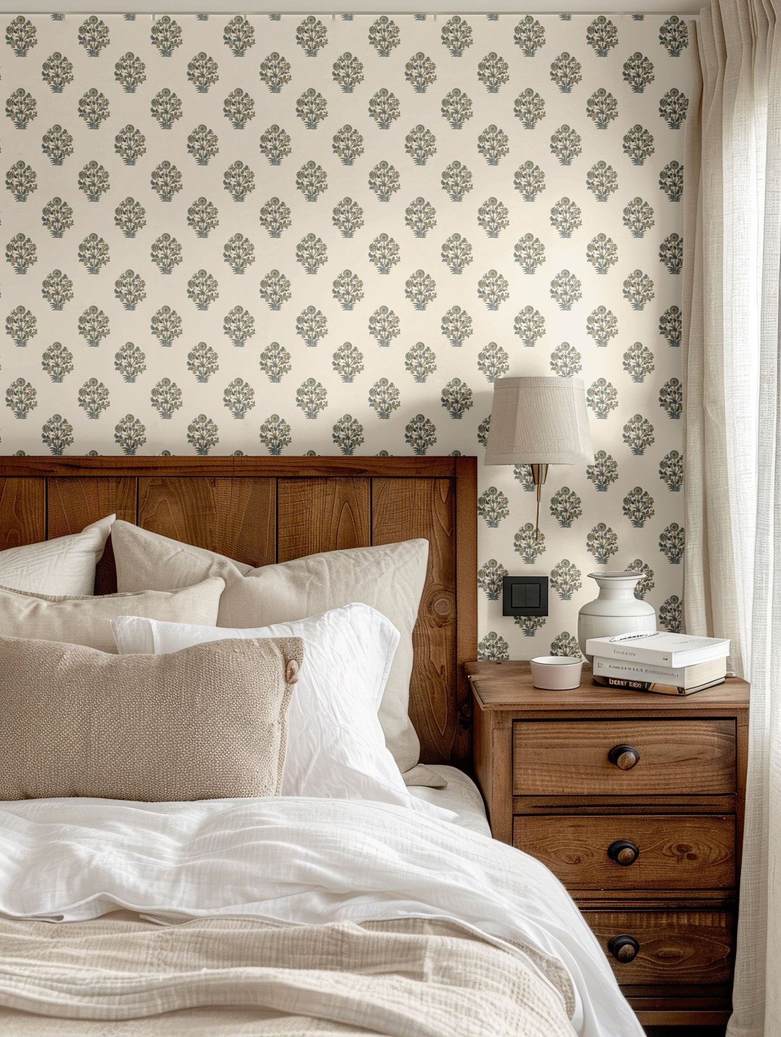 Cozy bedroom featuring a charming blue floral wallpaper paired with warm wooden furniture and neutral bedding for a serene atmosphere