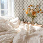 Bright and airy bedroom showcasing blue floral wallpaper, soft natural light, and minimalist decor for a refreshing feel