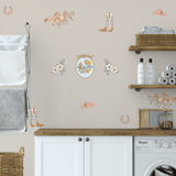 Peel-and-stick wall decals featuring horses, cowboy boots, hats, and floral accents, styled in a rustic laundry room