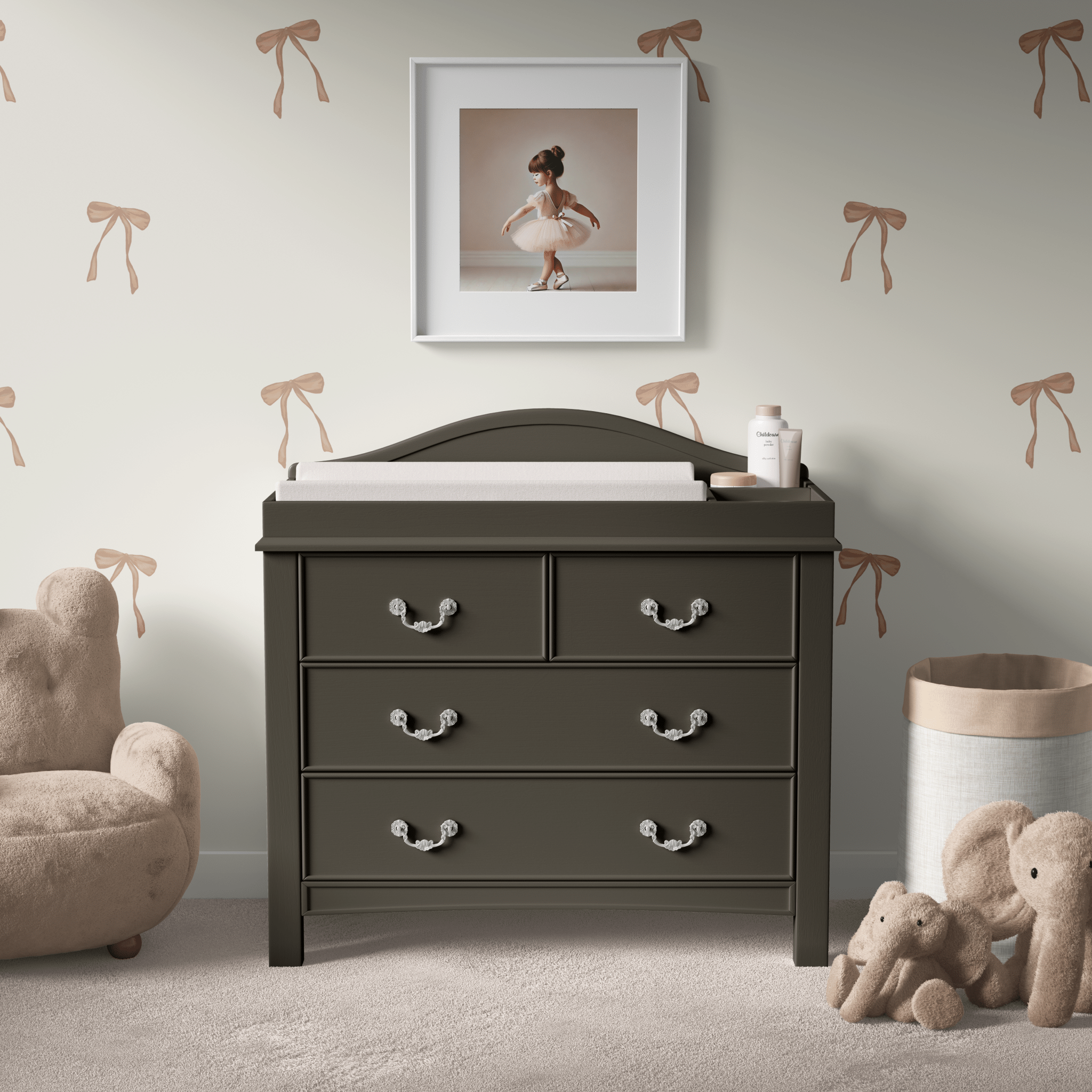 Ballerina-themed nursery with a black dresser and wall adorned with delicate bow decals, creating a charming and whimsical ambiance