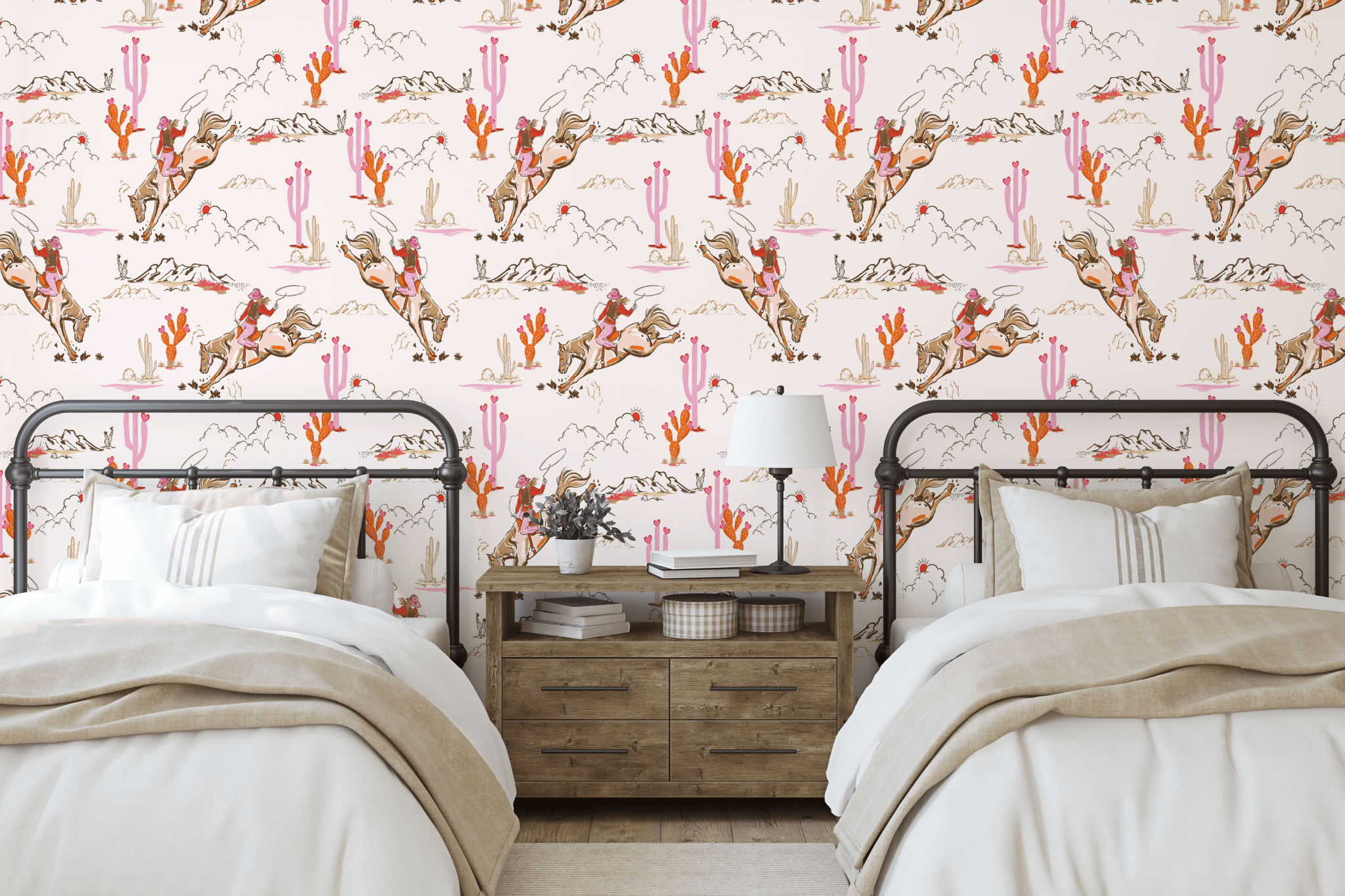Western-themed girls' bedroom decorated with Coral Rodeo wallpaper as an accent wall, showcasing cowgirl illustrations with desert landscapes and cactus details