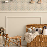 Charming cottagecore kids' room with vintage floral wallpaper, woven basket, and cozy plush toys, creating a nostalgic and whimsical atmosphere