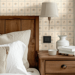 Cottagecore-inspired master bedroom with floral wallpaper, wooden headboard, and rustic decor, creating a serene and timeless retreat