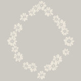 Close-up of the Daisy Chain wallpaper pattern, featuring a soft sage green background with delicate daisy flowers arranged in a charming circular design