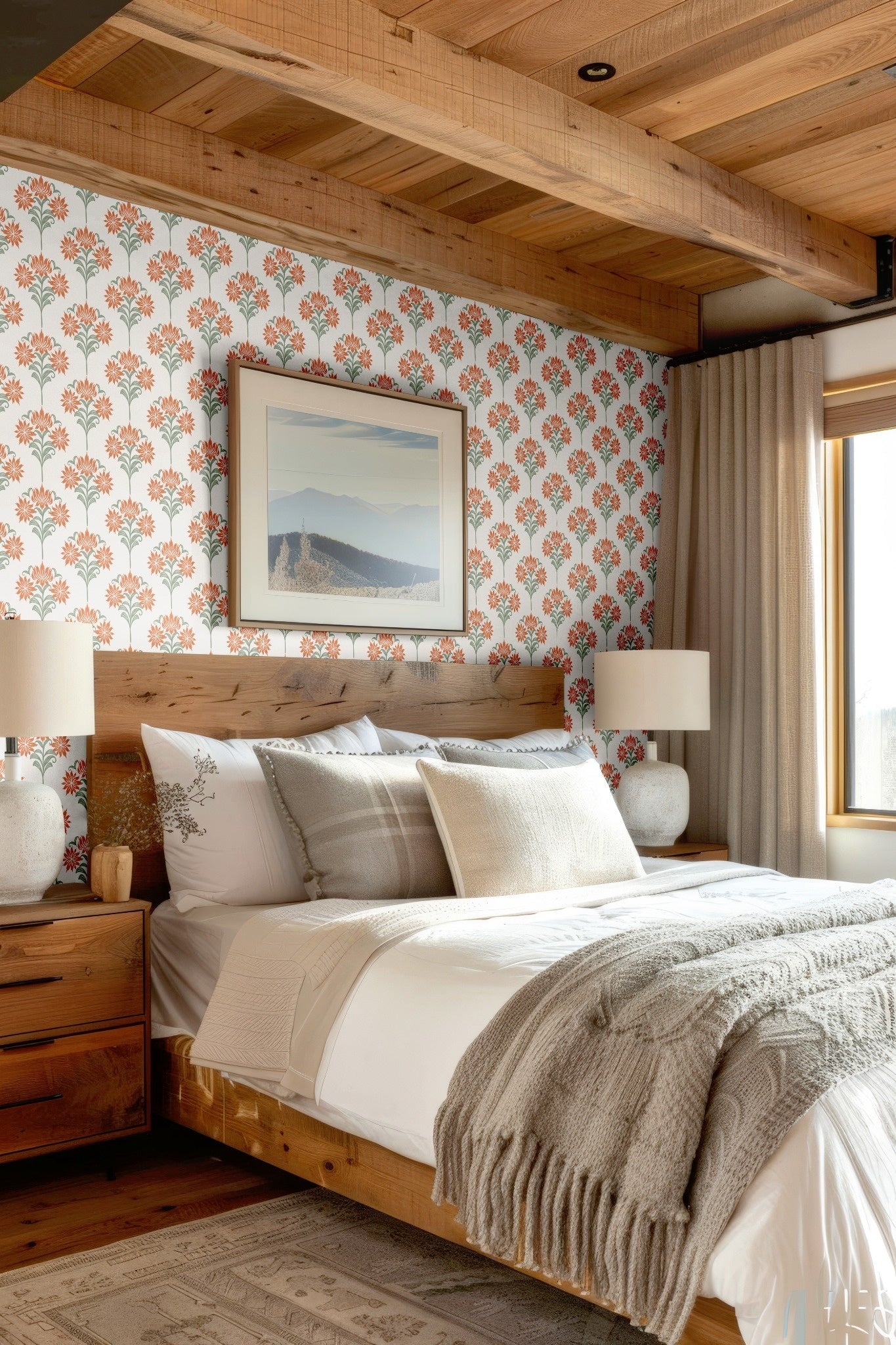 A cozy bedroom with a warm wooden bed frame and floral damask wallpaper featuring soft orange blooms