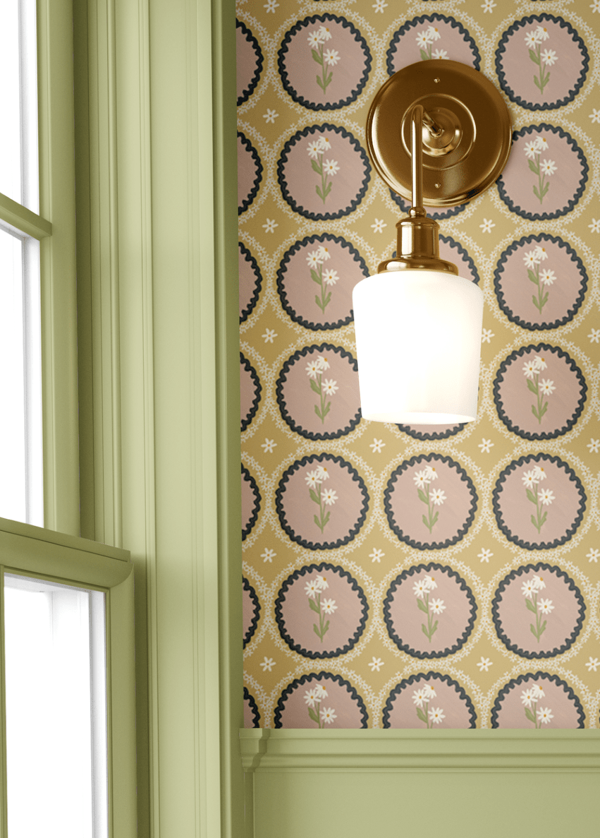 A sage green panel wall with brass sconce lighting, complemented by mustard yellow floral scalloped wallpaper for a sophisticated farmhouse-inspired look.