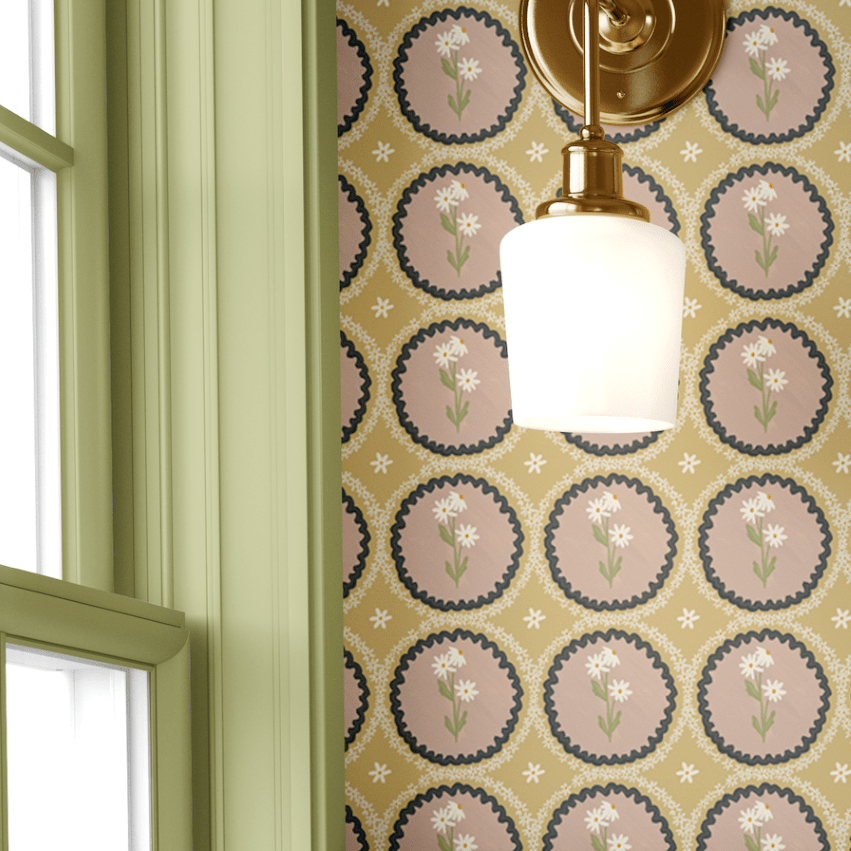 A sage green panel wall with brass sconce lighting, complemented by mustard yellow floral scalloped wallpaper for a sophisticated farmhouse-inspired look.