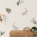 Close-up of Enchanted Rabbit wall decals in a nursery setting with bunnies, leaves, and flowers.