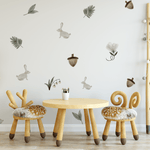 Enchanted Rabbit wall decals in a playroom with soft, neutral tones, including bunnies, leaves, and acorns for a whimsical forest look