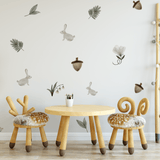 Enchanted Rabbit wall decals in a playroom with soft, neutral tones, including bunnies, leaves, and acorns for a whimsical forest look