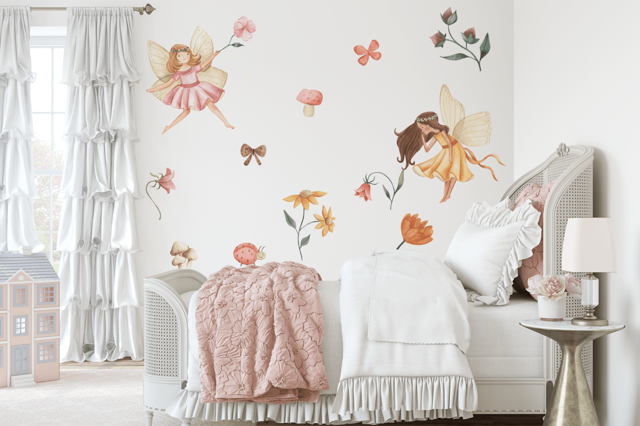 A whimsical girls' bedroom featuring fairy garden decals on the wall, with delicate fairies, flowers, mushrooms, and butterflies. The white bedding with pink accents and floral decor creates a magical and enchanting space