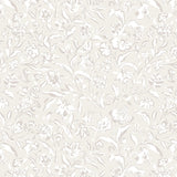 A close-up view of a beige wallpaper with a delicate floral pattern in white and light grey. The design features intricate flowers and leaves, creating a soft, elegant, and vintage-inspired look.