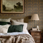 Folksy Wallpaper in Rustic Bedroom with Cozy Bedding and Earthy Tones.