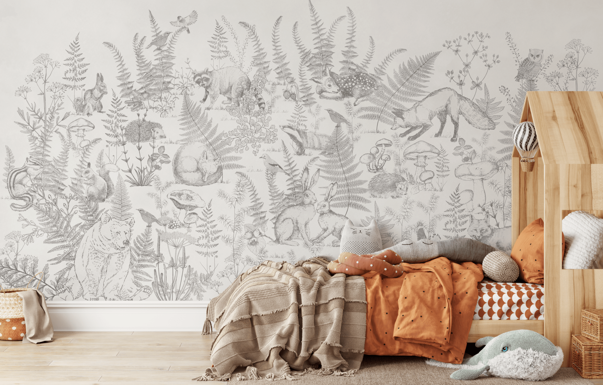 Children's bedroom with a large forest-themed mural showcasing various woodland animals and plants, perfect for creating an adventurous space