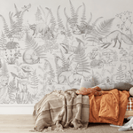 Children's bedroom with a large forest-themed mural showcasing various woodland animals and plants, perfect for creating an adventurous space