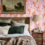 Cozy bedroom featuring Western-inspired heartland cactus wallpaper with warm tones, paired with a neutral bedding palette and rustic decor elements