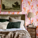 Cozy bedroom featuring Western-inspired heartland cactus wallpaper with warm tones, paired with a neutral bedding palette and rustic decor elements