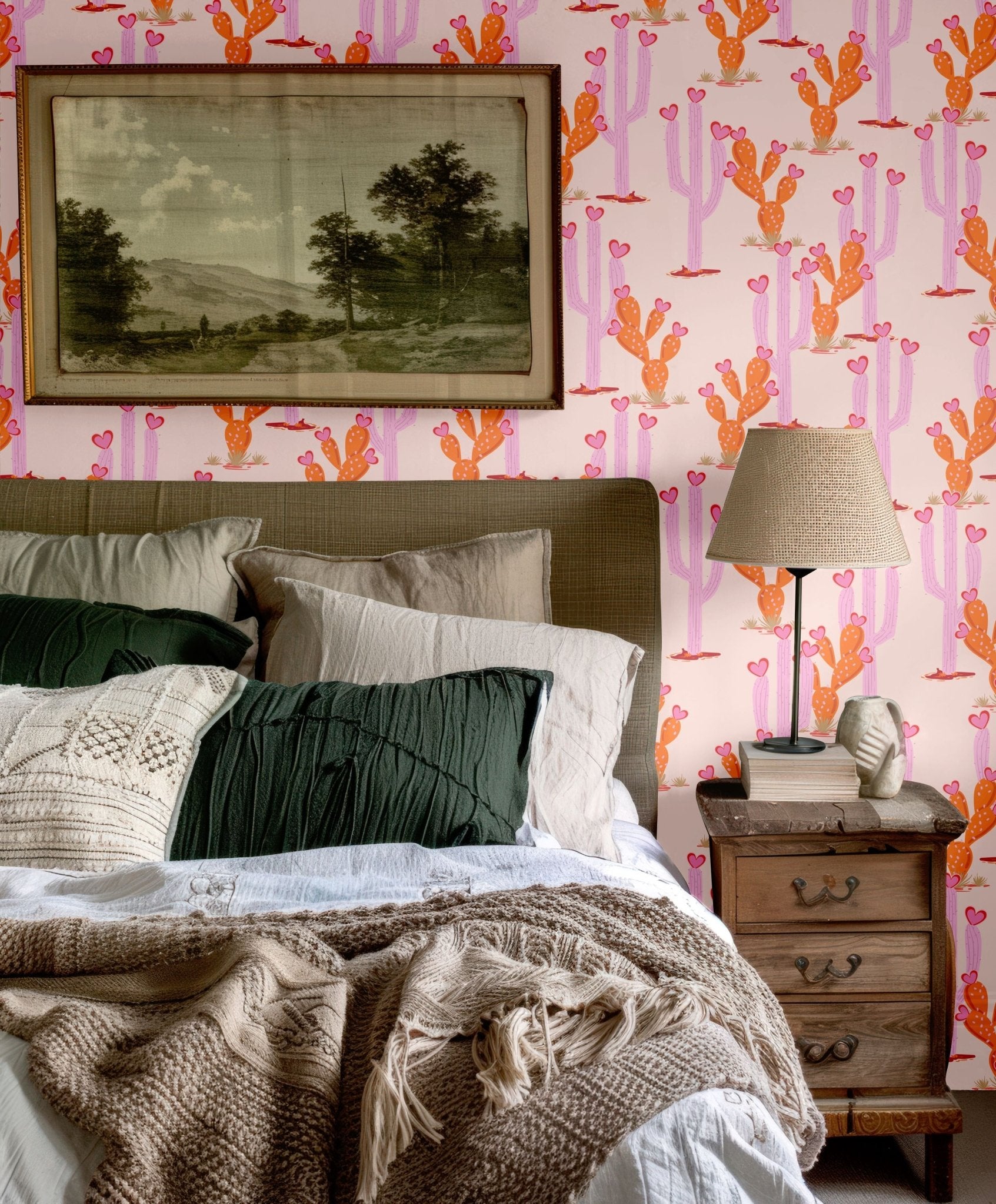 Cozy bedroom featuring Western-inspired heartland cactus wallpaper with warm tones, paired with a neutral bedding palette and rustic decor elements