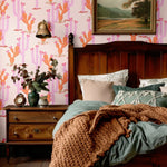 Classic bedroom with Western-style cactus wallpaper, vintage furniture, and warm textiles for a charming and nostalgic vibe