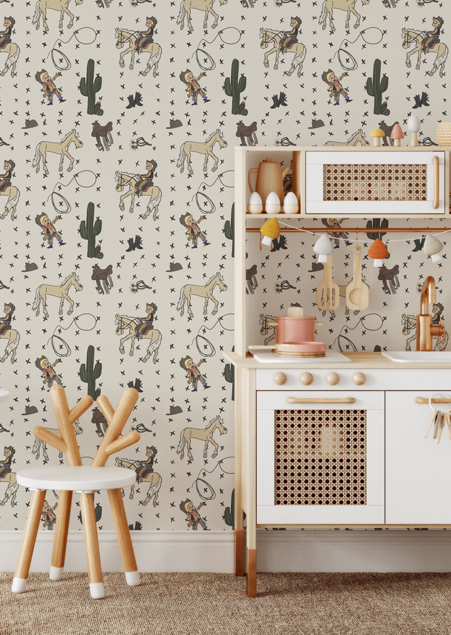 Kids' play kitchen setup with Howdy Partner cartoon cowboy wallpaper, showing illustrations of cowboys, horses, and Western elements like cacti and cowboy boots on the wall