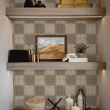 Decorative shelf with Mediterranean tile wallpaper in the background, creating a rustic and refined backdrop for neutral home decor pieces