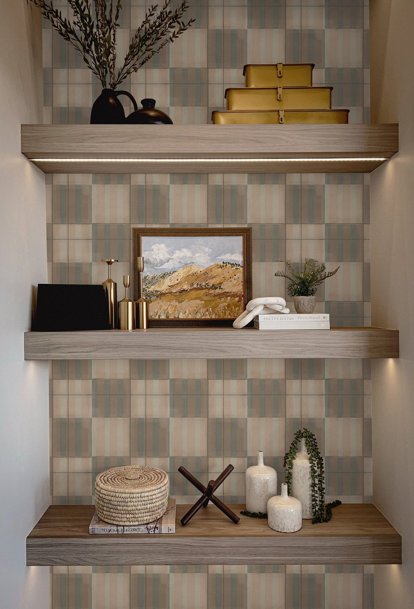 Decorative shelf with Mediterranean tile wallpaper in the background, creating a rustic and refined backdrop for neutral home decor pieces