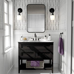 Bold black and white wallpaper in modern bathroom with double sconce lighting