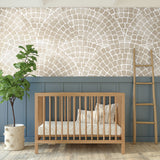 Natural Mosaic Tile wallpaper in a nursery featuring a wooden crib, blue wainscoting, and green plant