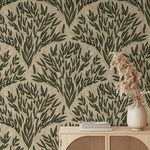 A natural and serene interior space featuring a beige olive branch wallpaper design. A modern cabinet with rattan detailing is placed against the wallpaper, with a vase of pampas grass on top.