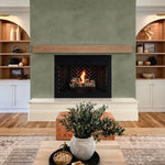 Wallpaper on fireplace feature wall with built-in shelving – olive green wallpaper fireplace, modern rustic wall decor, green limewash mural