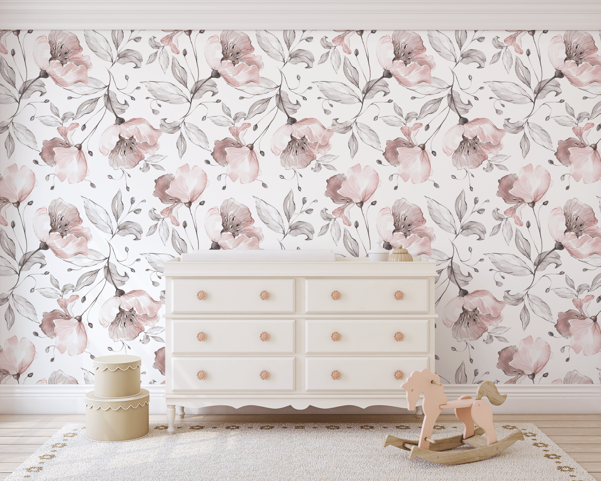 Nursery room with large blush floral wallpaper, white dresser with peach knobs, wooden rocking horse, and scalloped yellow storage.