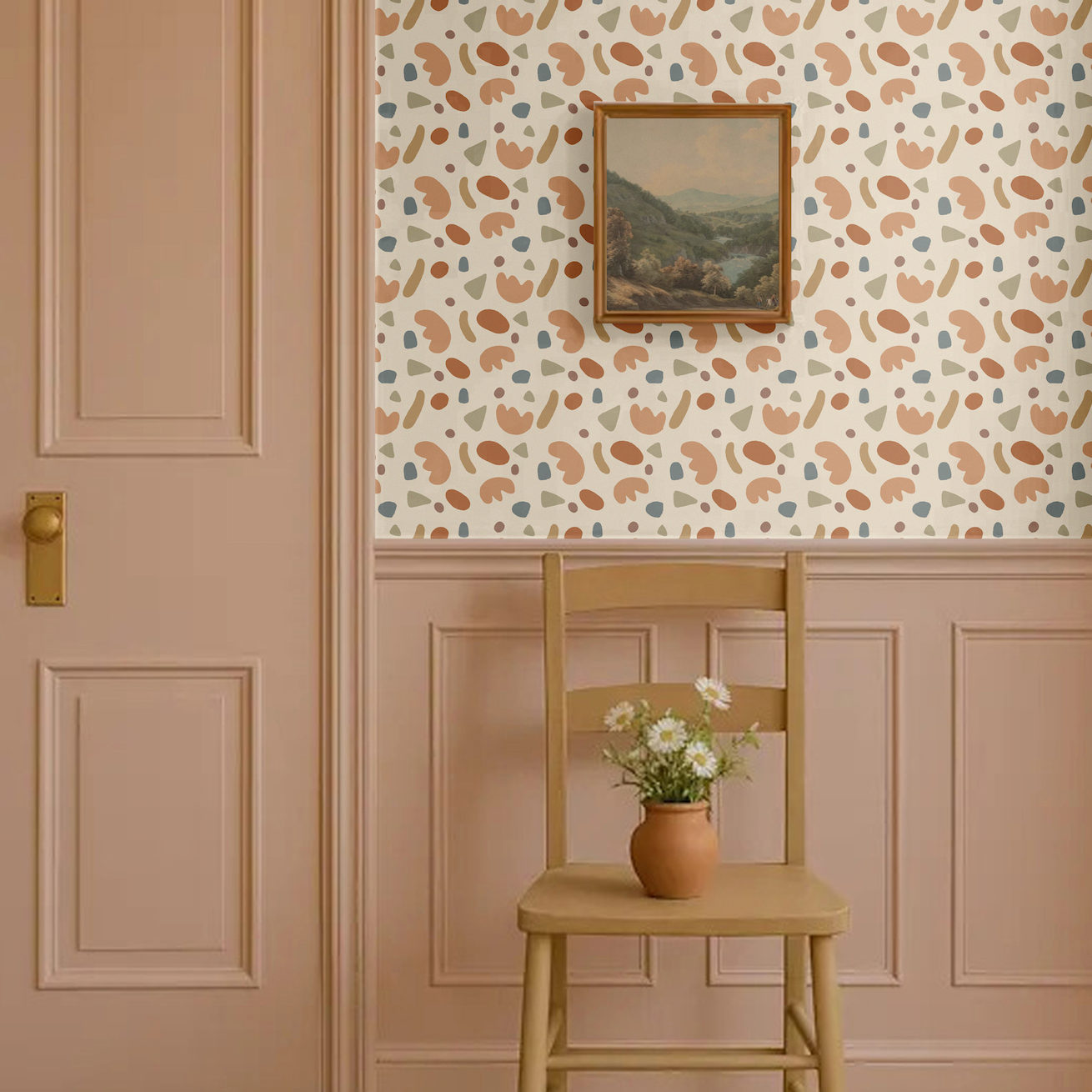 Playful shapes wallpaper in abstract retro tones of terracotta, beige, olive green, and blue, styled in a classic entryway with pink wainscoting