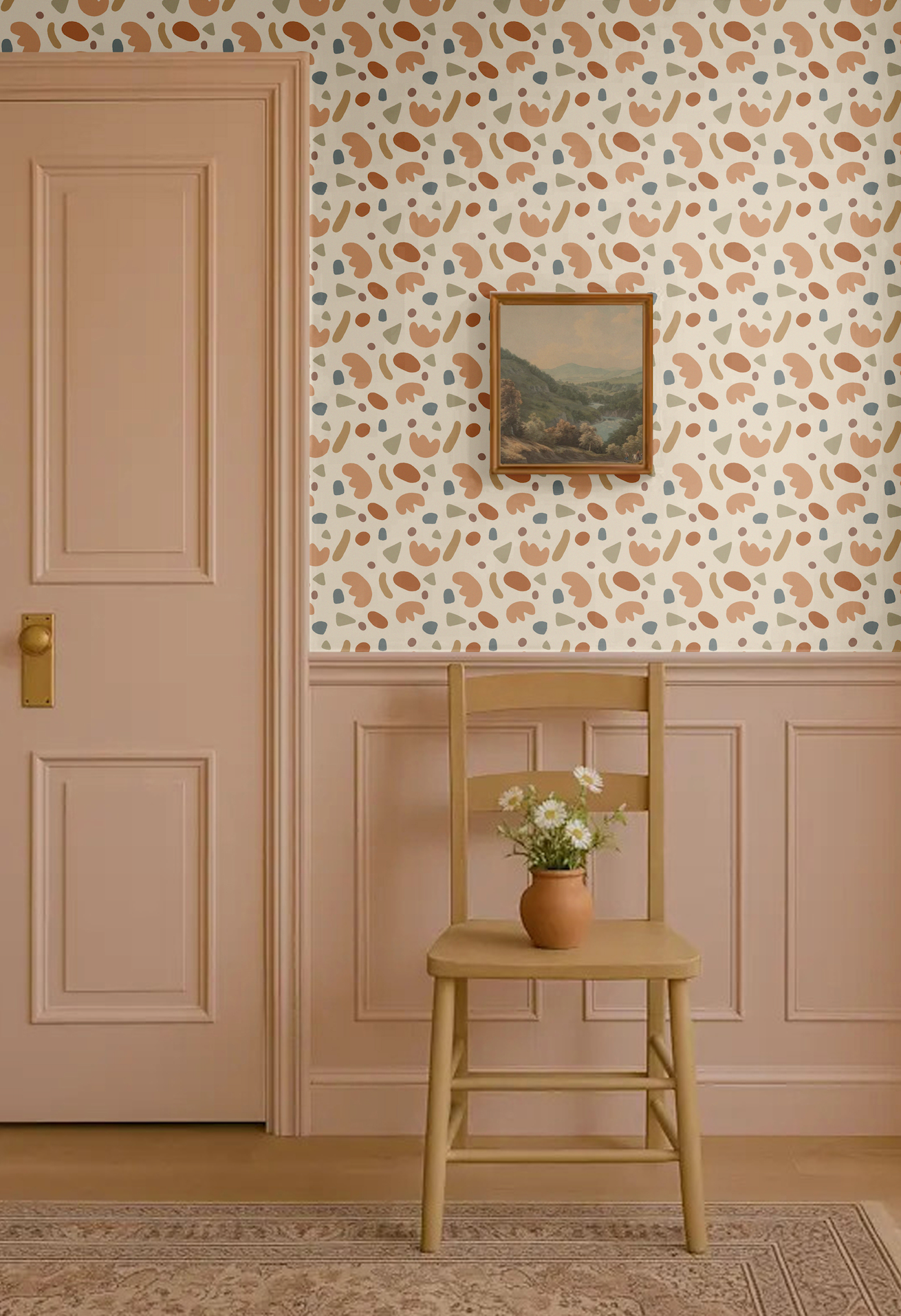 Playful shapes wallpaper in abstract retro tones of terracotta, beige, olive green, and blue, styled in a classic entryway with pink wainscoting