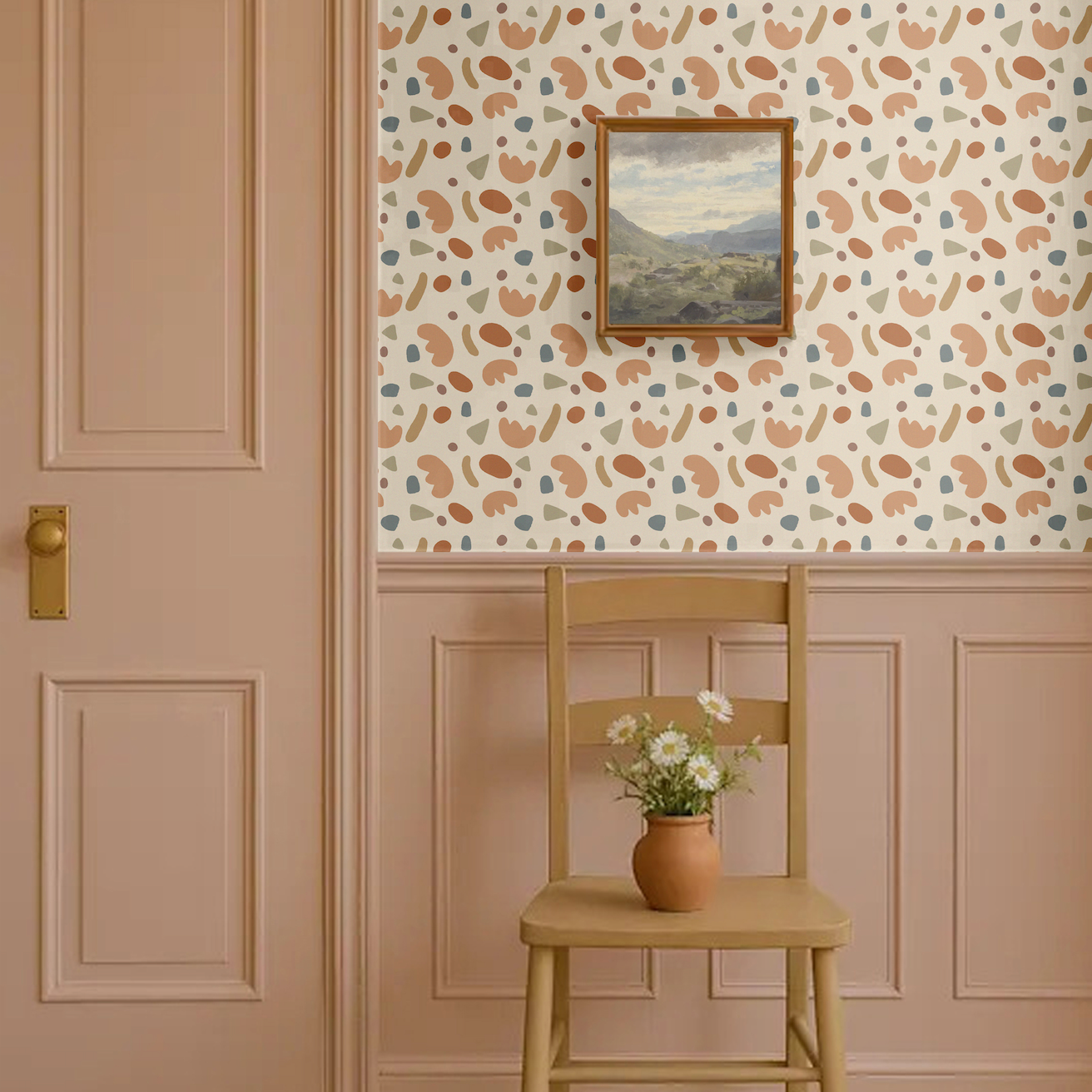 Playful shapes wallpaper in abstract retro tones of terracotta, beige, olive green, and blue, styled in a classic entryway with pink wainscoting