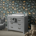 Dinosaur-themed wall decor in a child's room with Prehistoric Pals wallpaper in neutral colors