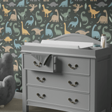 Dinosaur-themed wall decor in a child's room with Prehistoric Pals wallpaper in neutral colors