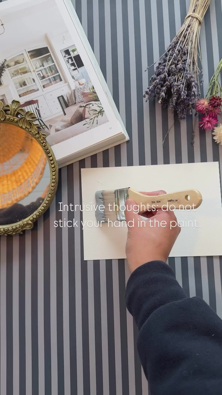 Beautiful  navy and light blue striped wallpaper paired with light blue paint.