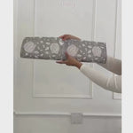 Unrolling the beautiful neutral floral wallpaper.