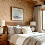 Rustic bedroom with Racing Pony wallpaper, wooden ceiling, and neutral decor.