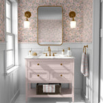 Vintage floral wallpaper in pink bathroom with blush vanity, gold fixtures, and wainscoting for an elegant botanical touch