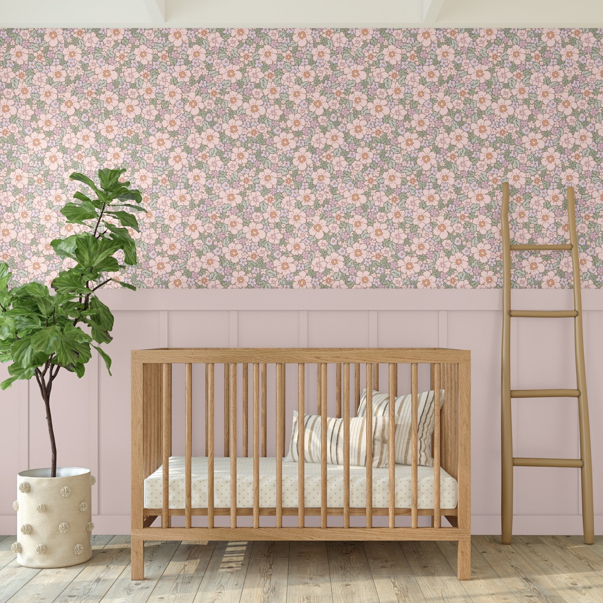 Rose floral wallpaper in gender-neutral nursery with wooden crib, blush paneling, and fiddle leaf fig plant for natural decor