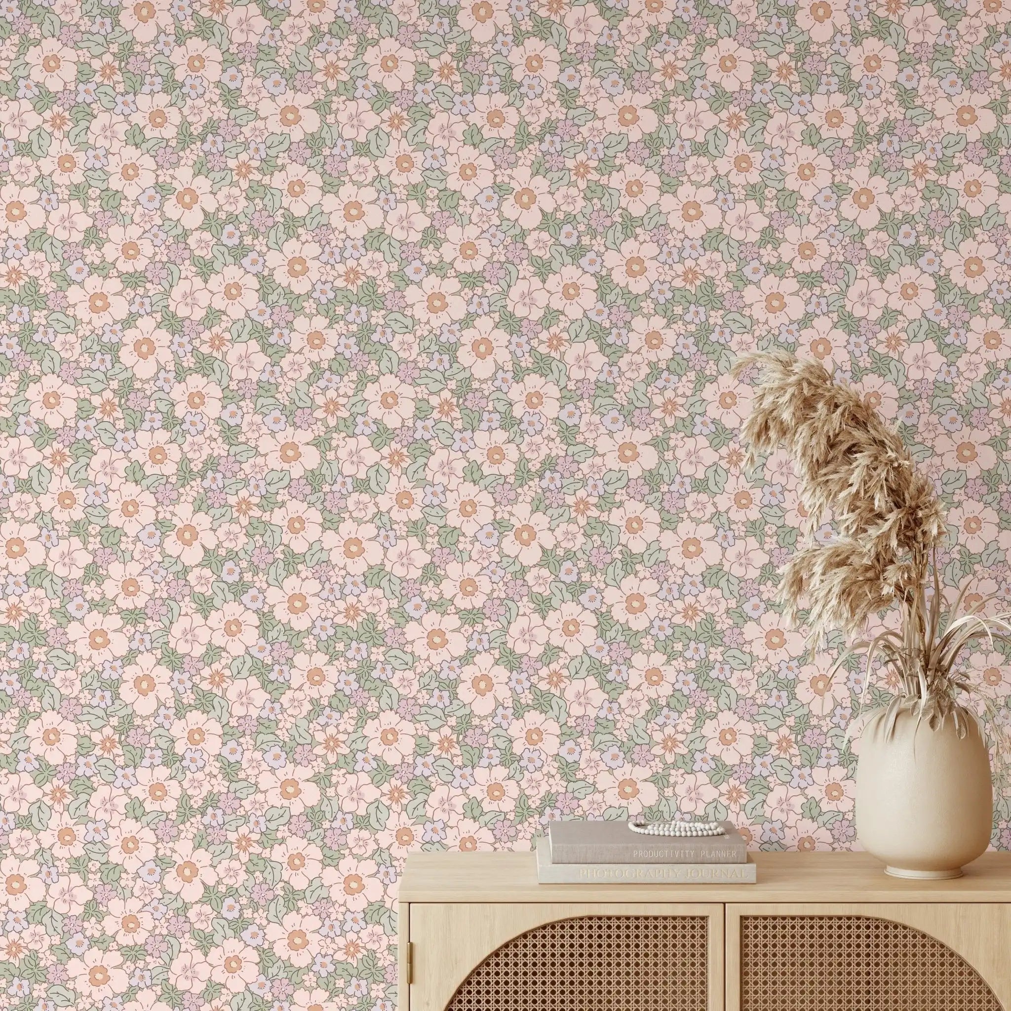 Cottage-inspired wallpaper with pink and purple flowers styled with neutral wood furniture and pampas grass in minimalist space