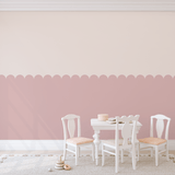 Close-up of pink scallop decals in a children's playroom for a subtle decorative touch.