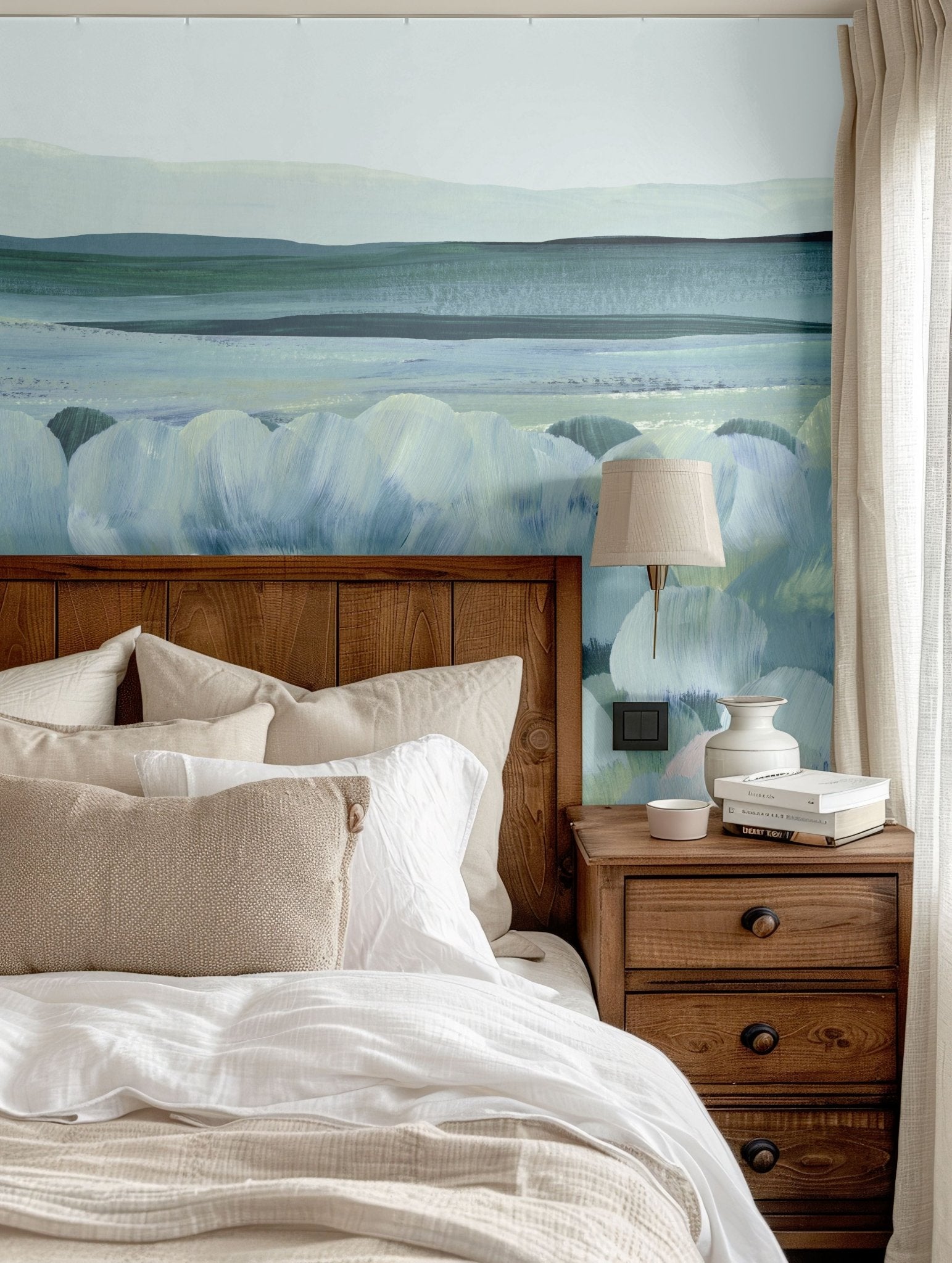 Abstract blue and green wall mural featured above a rustic wooden bed with beige linens.