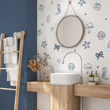 Navy coastal cowgirl decals in a modern bathroom with round mirror and wooden vanity