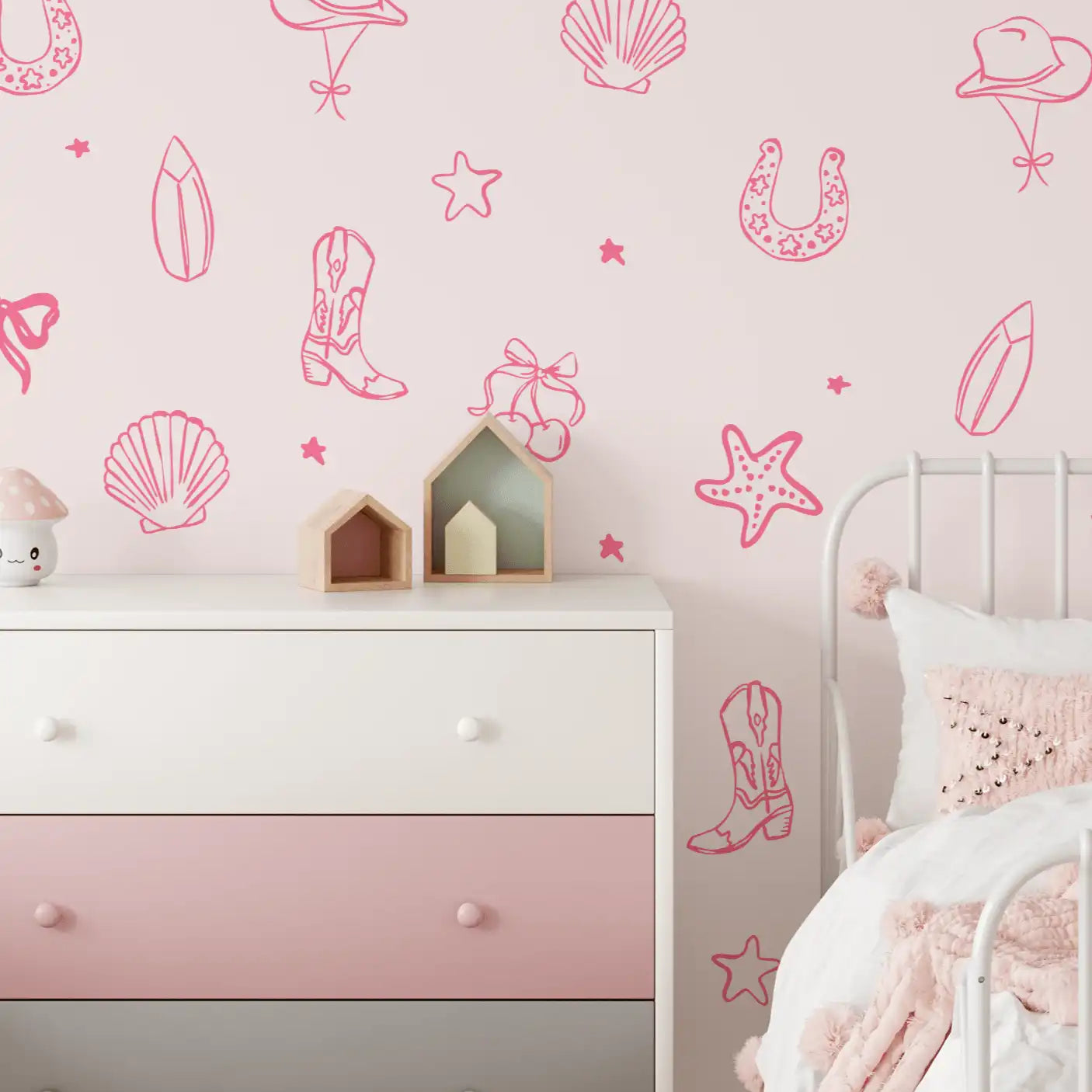 Pink coastal cowgirl wall decals in a girl's room with dresser and soft decor accents
