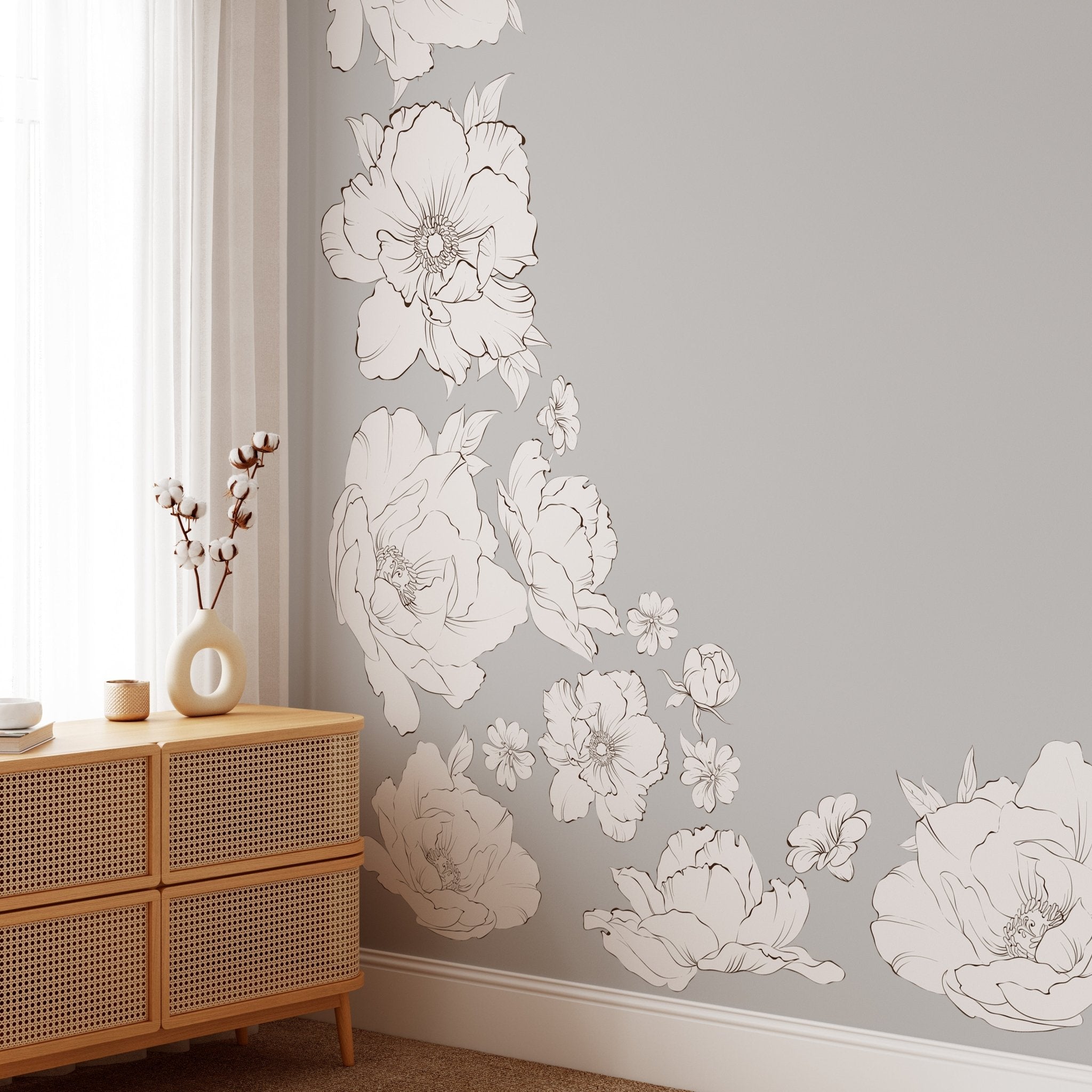 Modern home decor showcasing large, peel-and-stick peony wall decals in a minimalist setting. The removable flower decals elegantly frame a wicker chest and enhance the room's calm, neutral aesthetic