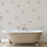 Simple Bow Wall Decals in green outline applied to a bathroom wall above a vintage bathtub